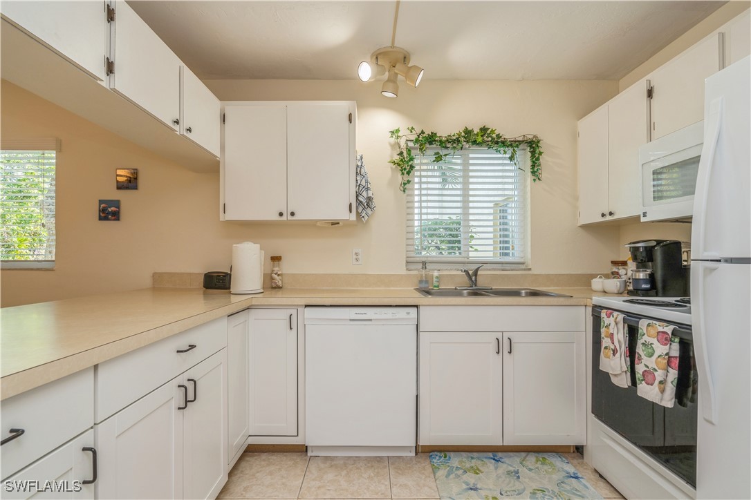 8049 Country Road, Unit 102 Fort Myers, FL 33919 - Photo 8 of 23 a kitchen with cabinets appliances a sink and a window