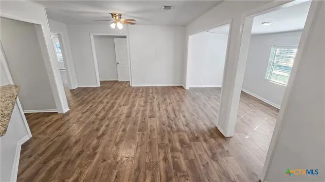 wooden floor in an empty room with a window