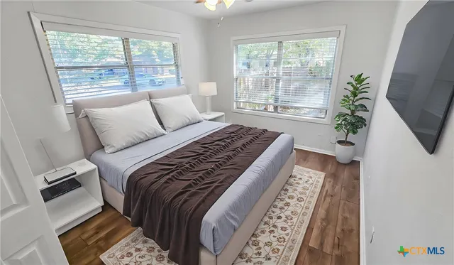 a bed sitting in a bedroom next to a window