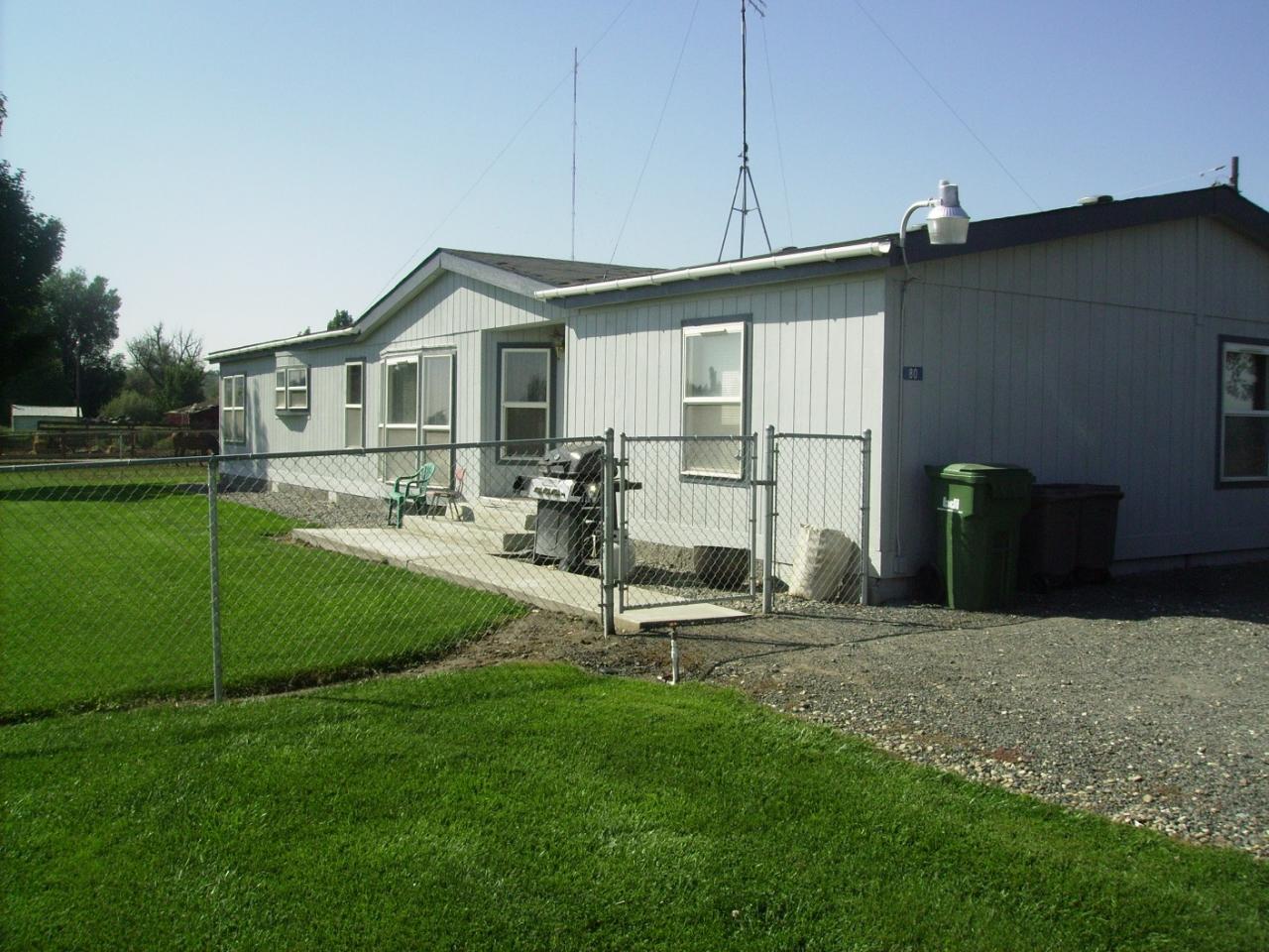 80 Rougk Lane Sunnyside, WA 98944 - Photo 1 of 9 a view of a house with backyard and porch