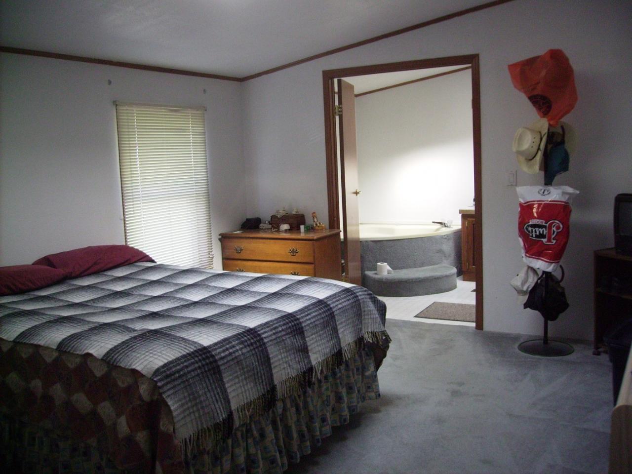80 Rougk Lane Sunnyside, WA 98944 - Photo 7 of 9 a bedroom with a bed and a lamp on dresser