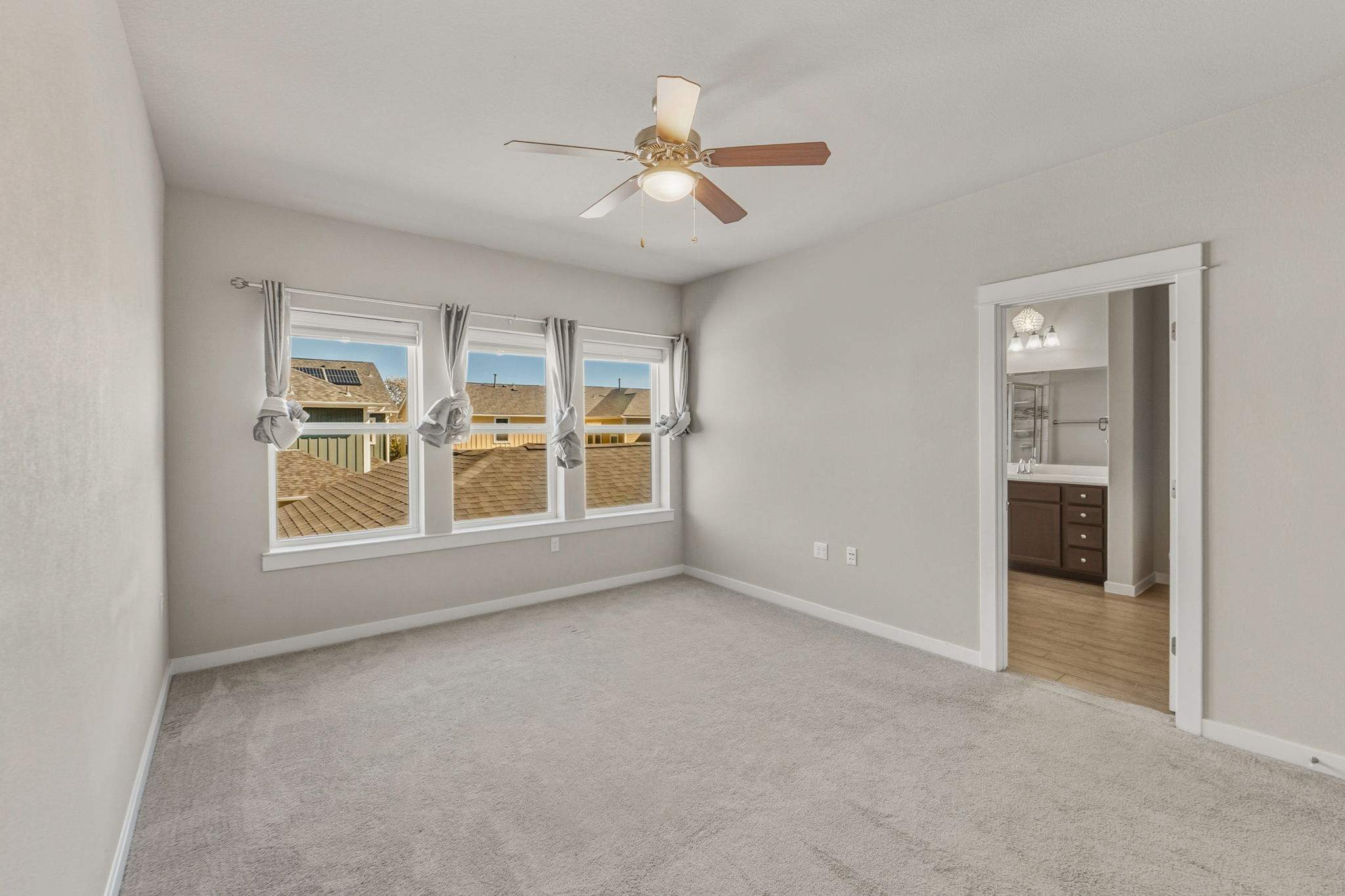 3919 Vaughan Street Austin, TX 78723 - Photo 22 of 40 A quiet retreat with a soothing color palette, featuring a ceiling fan for comfort and light.