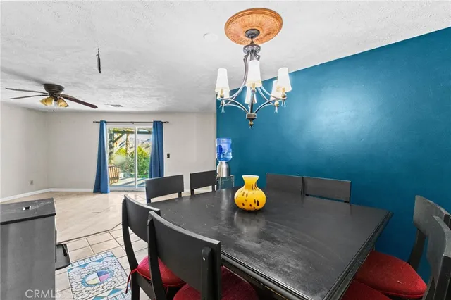a view of a dining room with a table and chairs