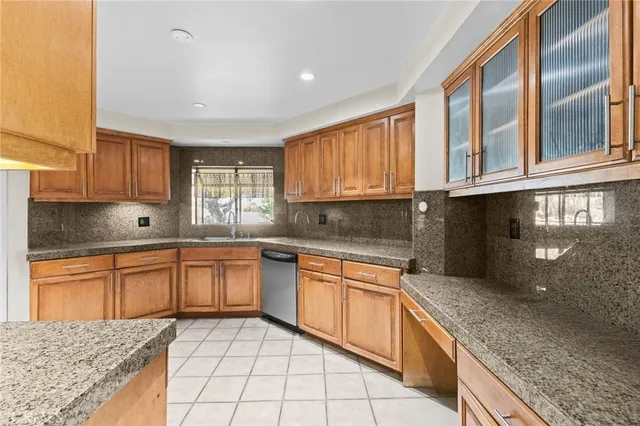 a kitchen with stainless steel appliances granite countertop a stove sink and cabinets