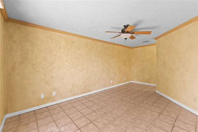 a view of a big room with wooden floor and table lamp