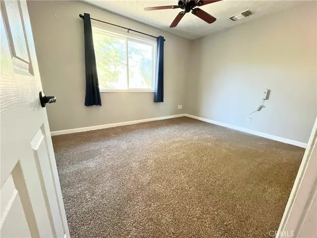 a view of an empty room and a window