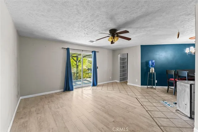 a view of an empty room with window and cabinet