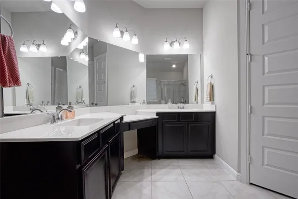 a bathroom with a sink vanity and a mirror
