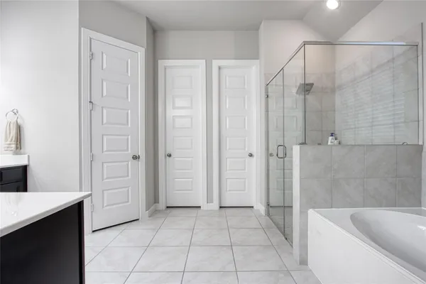 a bathroom with a bathtub and shower