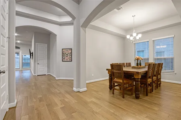 a view of a dining room with furniture and chandelier