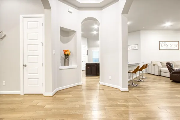 a view of a livingroom with wooden floor and furniture
