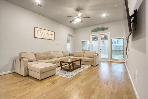 a living room with furniture and a chandelier
