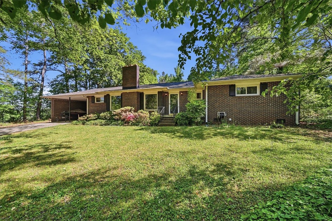 504 Jeb Stuart Avenue Anderson, SC 29621 - Photo 1 of 47 This classic brick residence features a lush lawn and mature trees, offering a private setting.