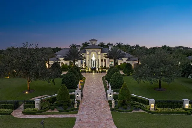 an aerial view of a house with yard garden and outdoor seating