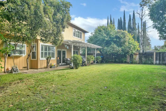 a front view of a house with a yard and trees