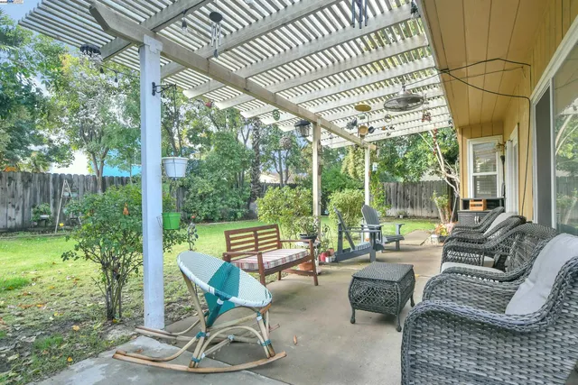 a building outdoor space with patio furniture and potted plants