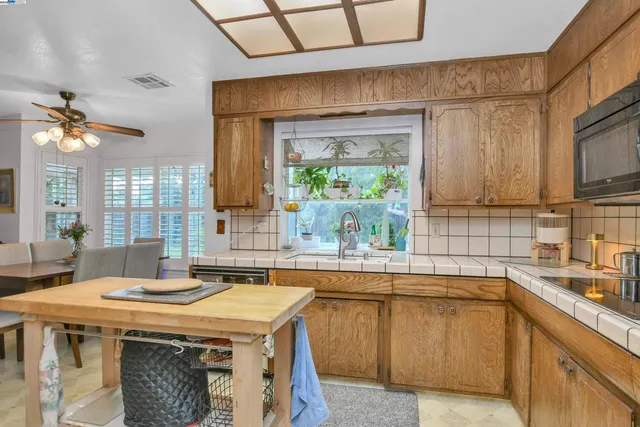 a kitchen with a stove a sink and a refrigerator