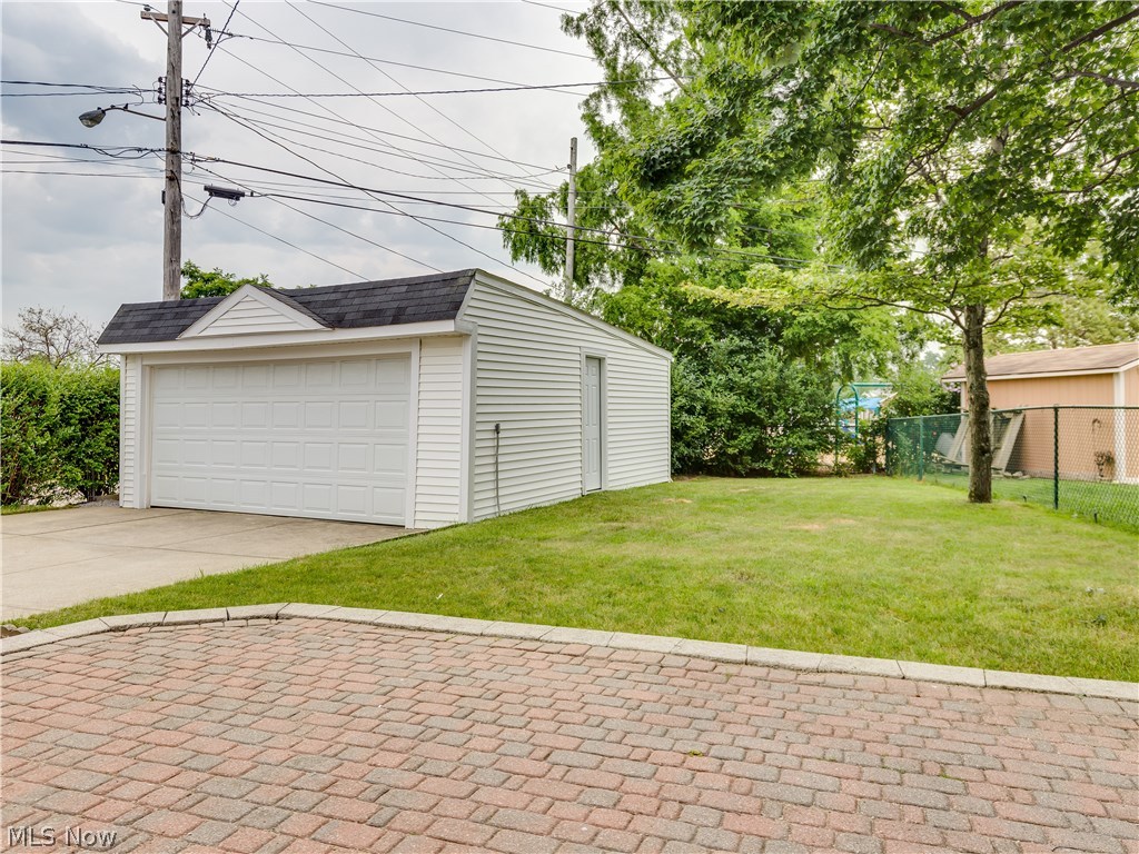1535 Chelmsford Road Cleveland, OH 44124 - Photo 18 of 19 View of the paver patio, partially fenced back yard and 2.5 car garage.