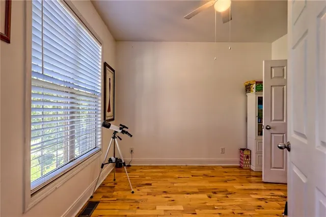a bedroom with a large bed and a book shelf