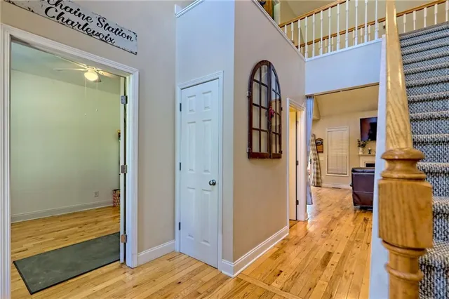 a bedroom with a bed wooden floor and window