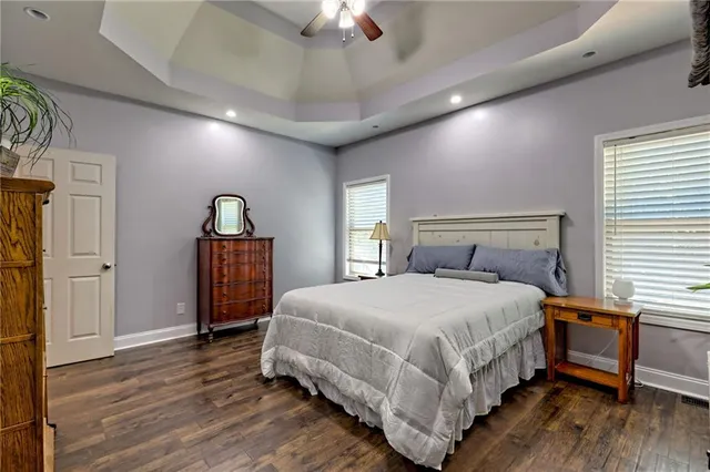 a bedroom with a bed a dresser and a book shelf