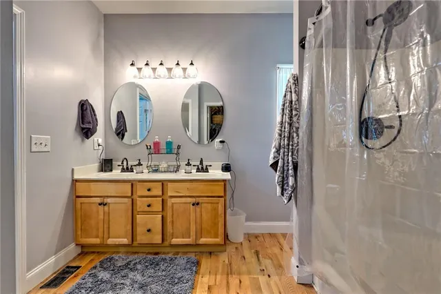 a bathroom with a sink a mirror and shower