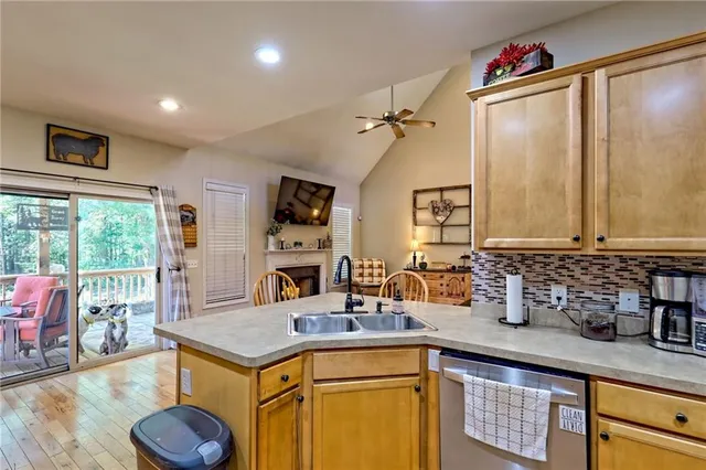 a view of a house with a big yard and large tree