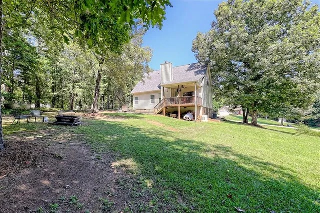 a view of a chair and tables in the back yard of the house