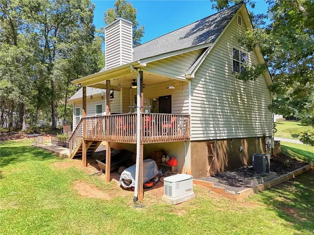 a view of a lush green forest with trees and houses