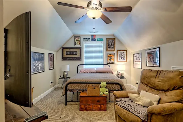 a bedroom with furniture and a ceiling fan