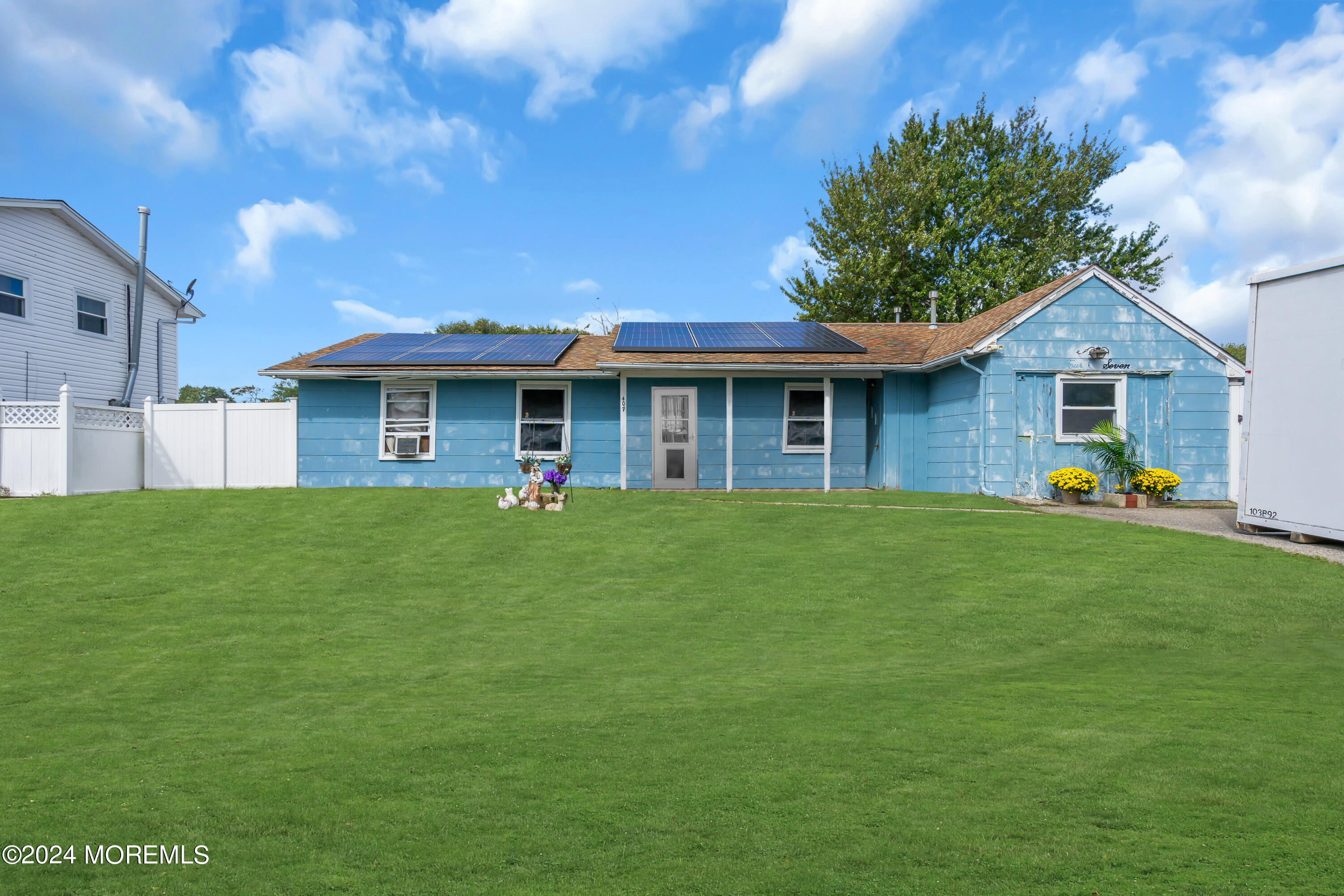 407 6th Street Waretown, NJ 08758 - Photo 2 of 9 a front view of a house with a garden