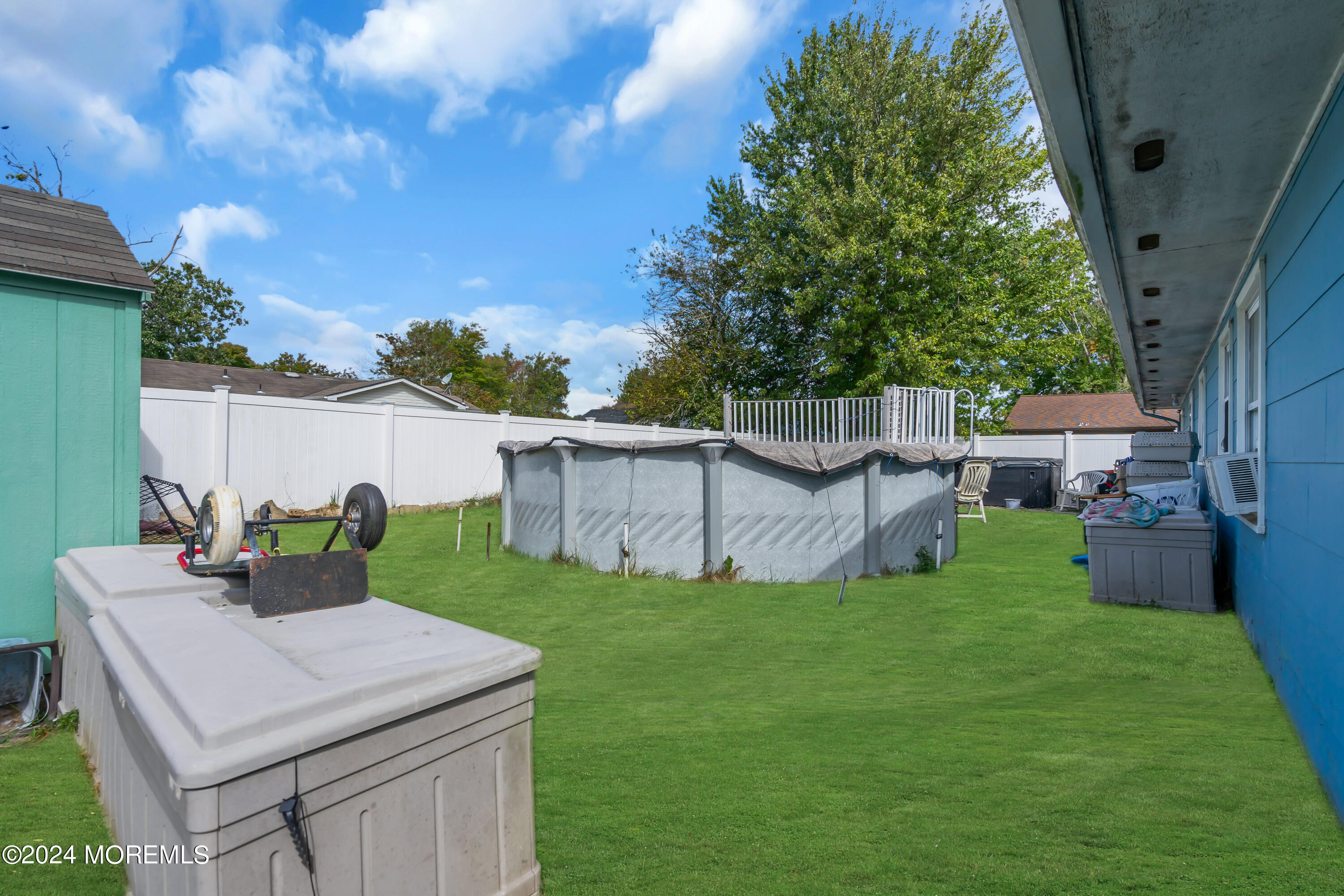 407 6th Street Waretown, NJ 08758 - Photo 7 of 9 a view of backyard of house and car parked