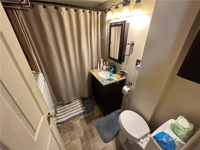 a bathroom with a sink toilet and shower