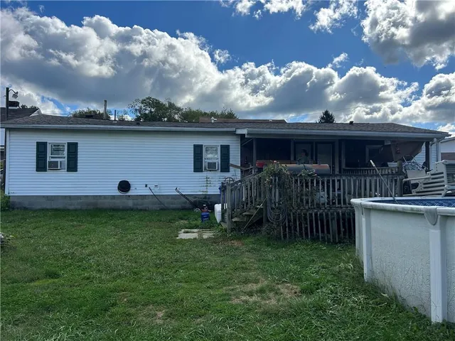 a backyard of a house with table and chairs