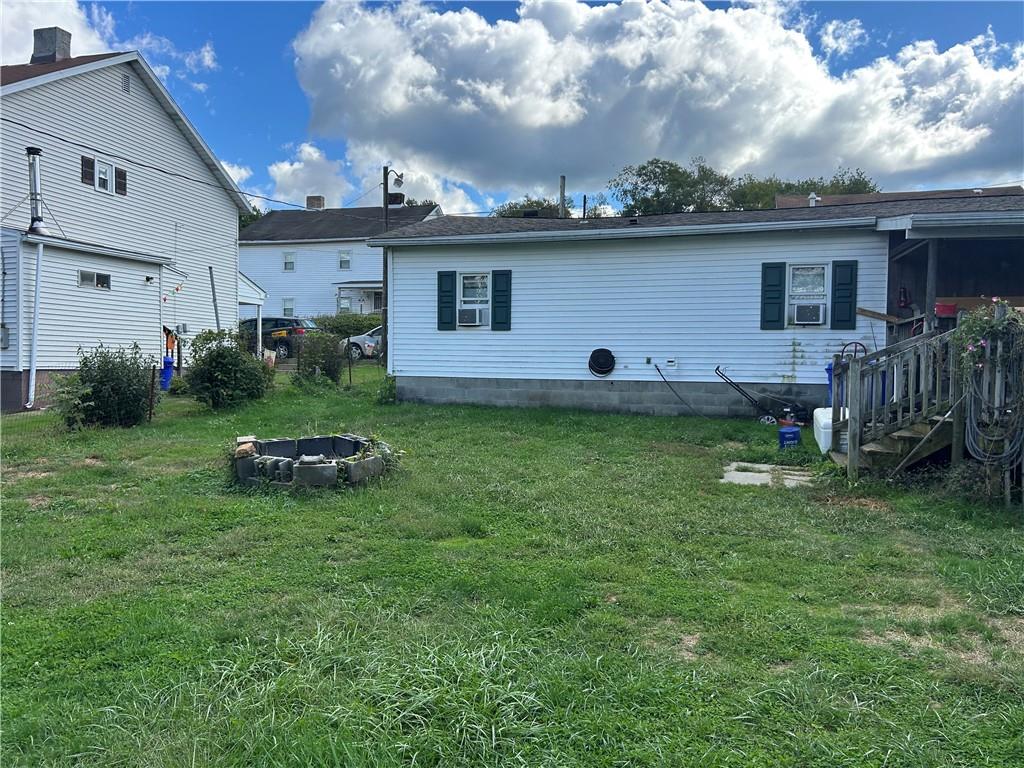 203 2nd Street Brownfield, PA 15416 - Photo 24 of 27 a backyard of a house with table and chairs
