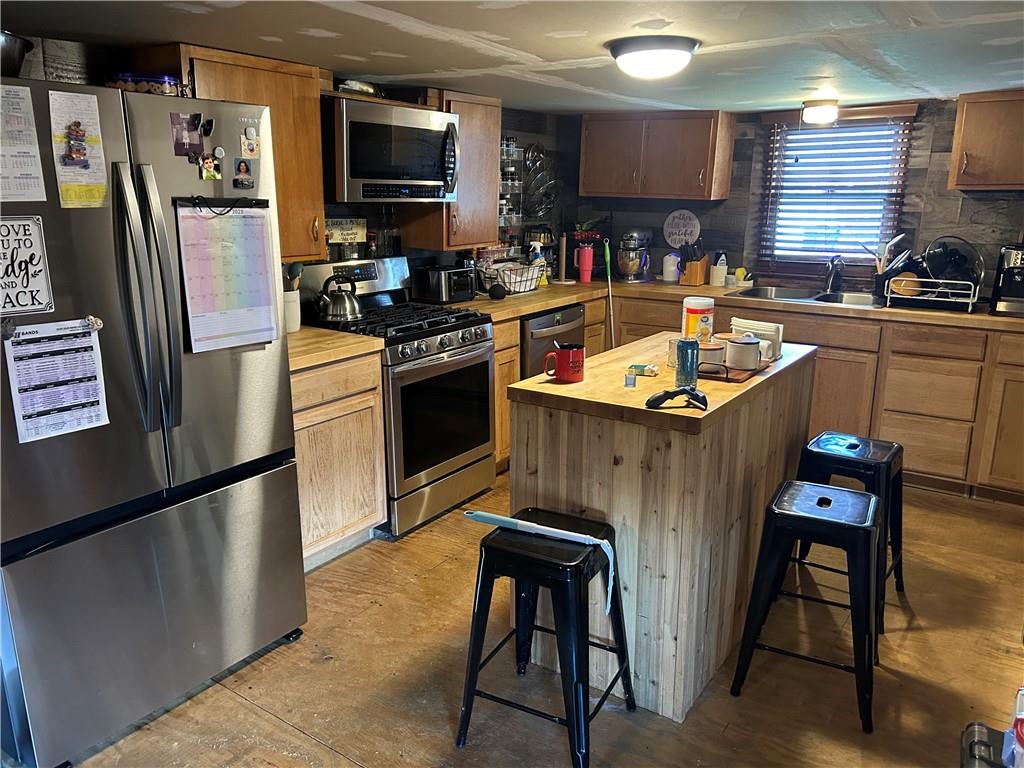 203 2nd Street Brownfield, PA 15416 - Photo 5 of 27 a kitchen with stainless steel appliances granite countertop a sink stove and refrigerator