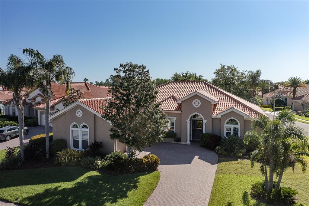 10701 Ruffino Court Trinity, FL 34655 - Photo 1 of 1 a front view of a house with a yard and potted plants