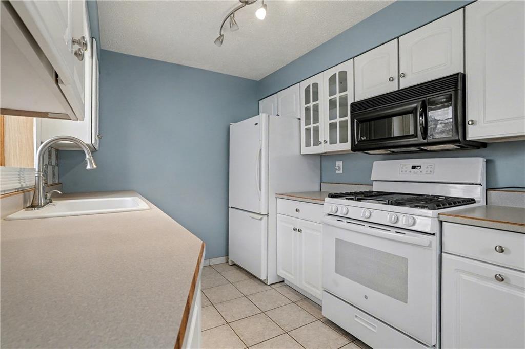 444 Violet Drive Lower Burrell, PA 15068 - Photo 7 of 19 a kitchen with stainless steel appliances a stove microwave and sink