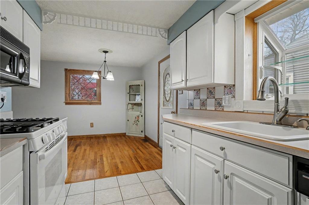 444 Violet Drive Lower Burrell, PA 15068 - Photo 8 of 19 a kitchen with a sink stove and cabinets