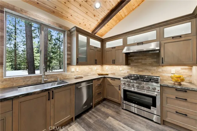 a kitchen with stainless steel appliances granite countertop a stove and a sink