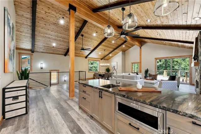 a kitchen with stainless steel appliances granite countertop a sink a stove and cabinets