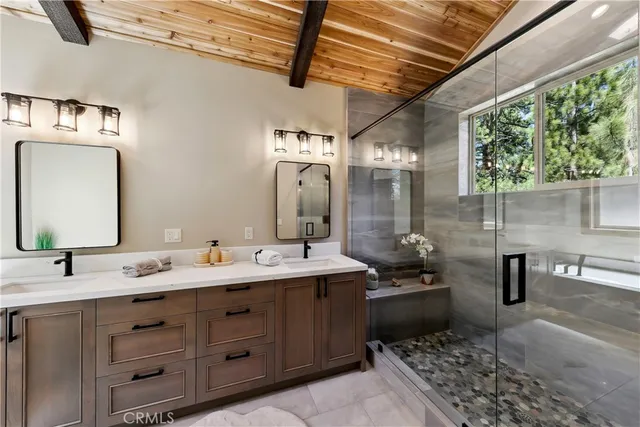 a bathroom with a sink double vanity and a mirror