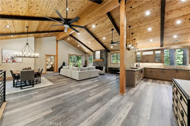 a living room with lots of furniture and kitchen view