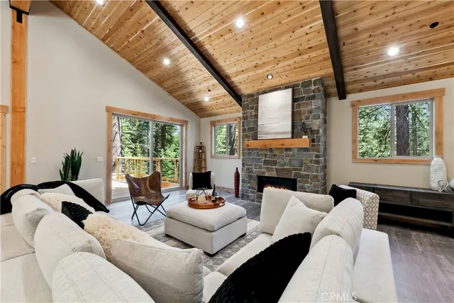 a living room with furniture a fireplace and a large window