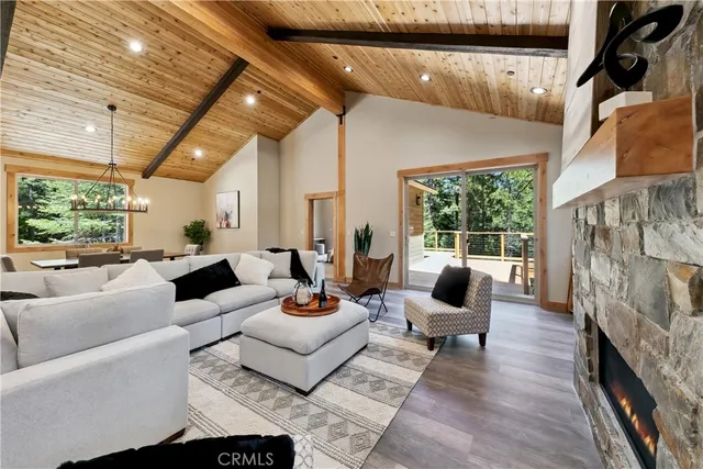 a living room with fireplace furniture and a floor to ceiling window