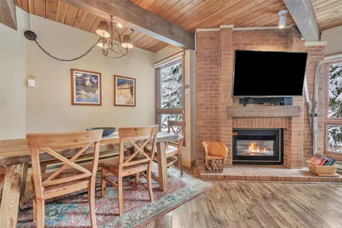 a living room with a fireplace and a flat screen tv