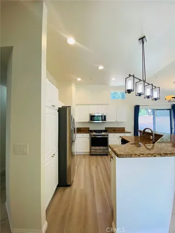 a kitchen with a refrigerator a stove and a sink