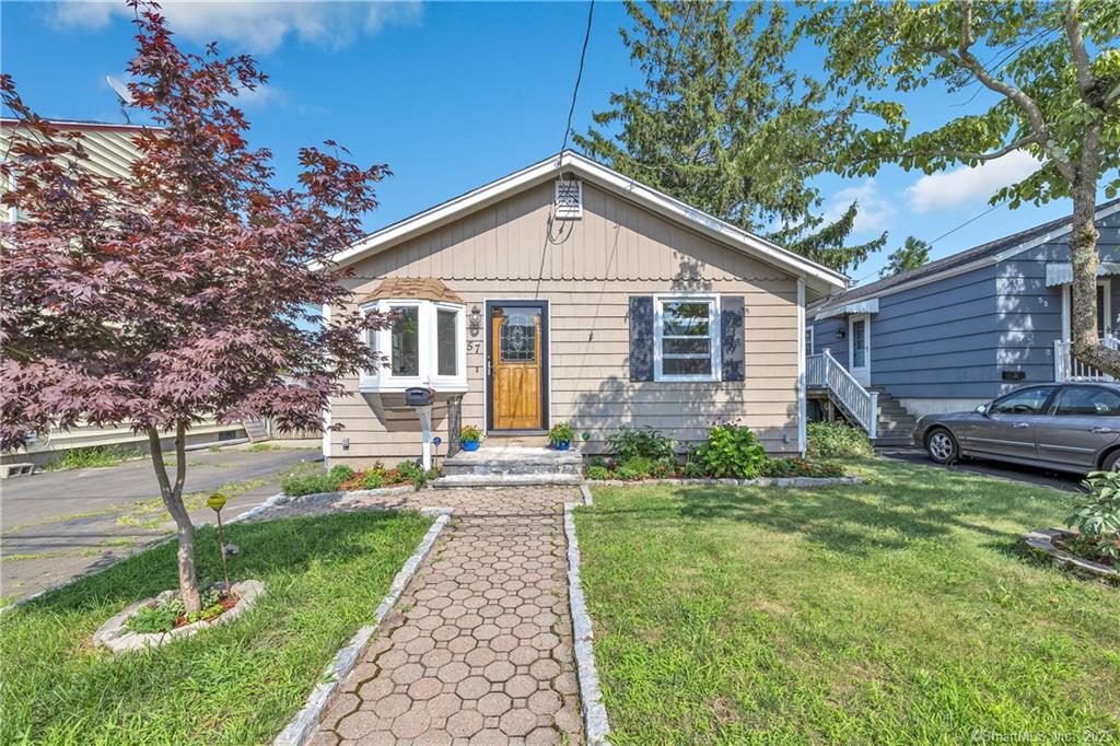 a front view of house with yard and green space