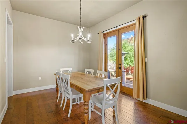 a bathroom with a granite countertop sink a mirror and painting on the wall