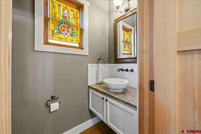 a kitchen with granite countertop a sink stove and cabinets